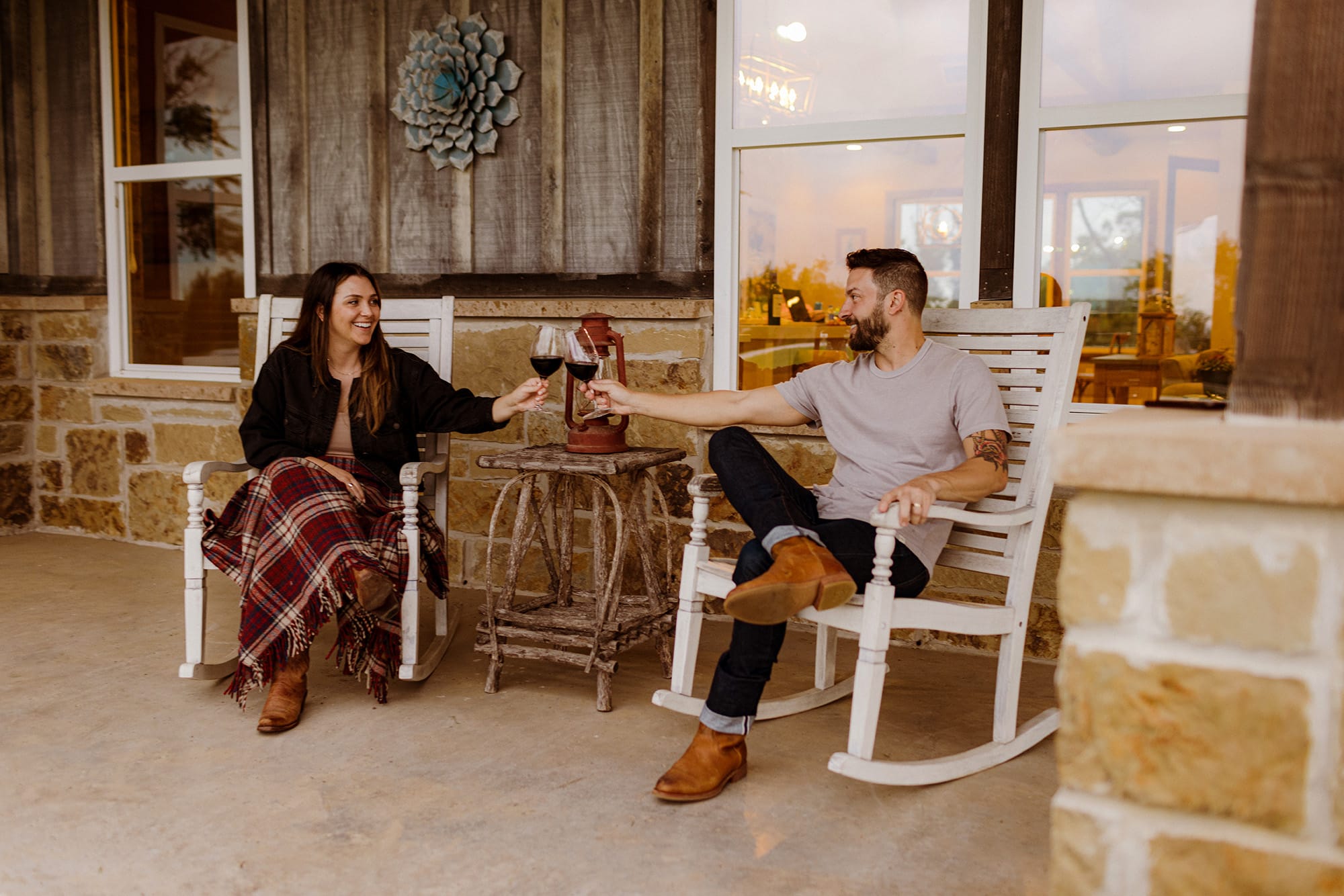 Couple enjoying the limestone porch at Camp Hideaway Fredericksburg — private outdoor stay in the Texas Hill Country
