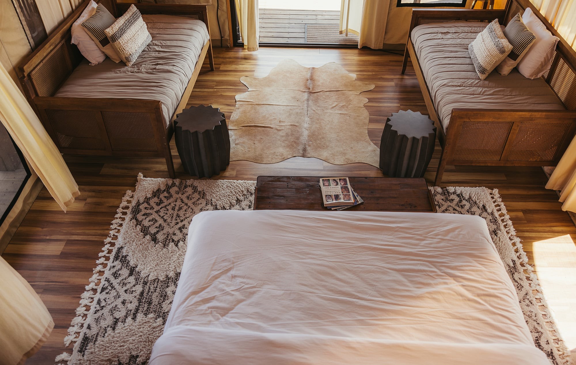 Luxury tent suite interior at Camp Hideaway Fredericksburg — premium accommodations for corporate groups